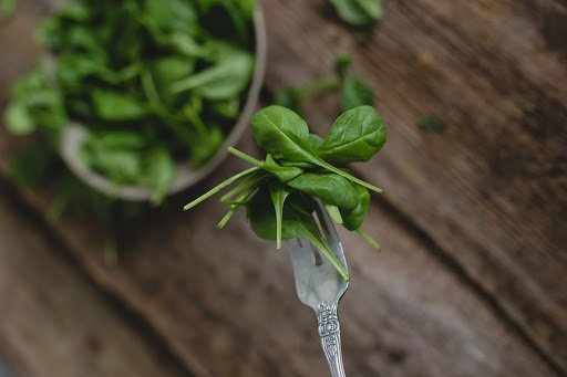 Food. Spinach on a wooden table