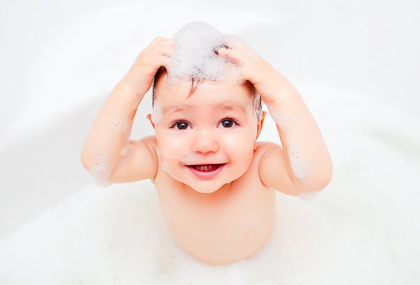baby in a bath tub with foam