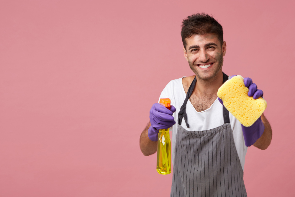 Smiling man holding sponge detergent