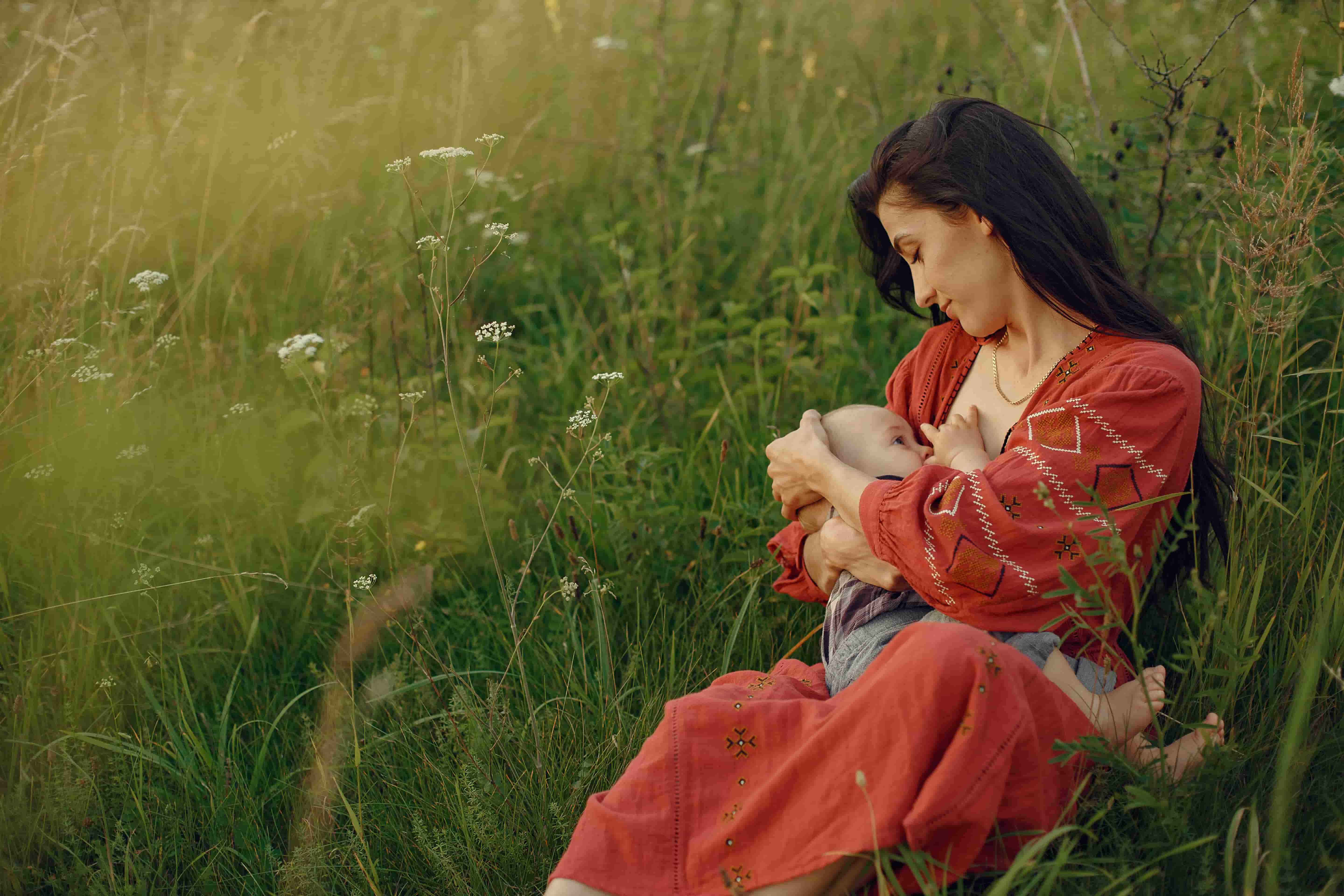 A beautiful image of a women feeding her cute baby girl.