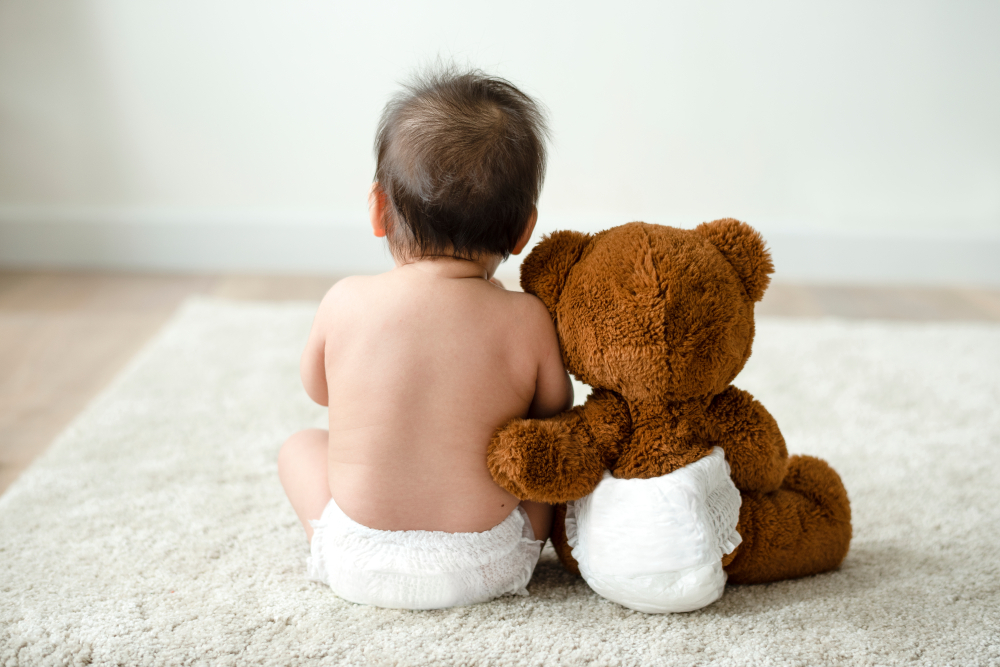 baby and teddy in single use diapers
