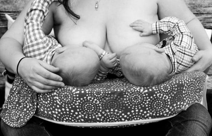 Breast feeding twins - black and white image