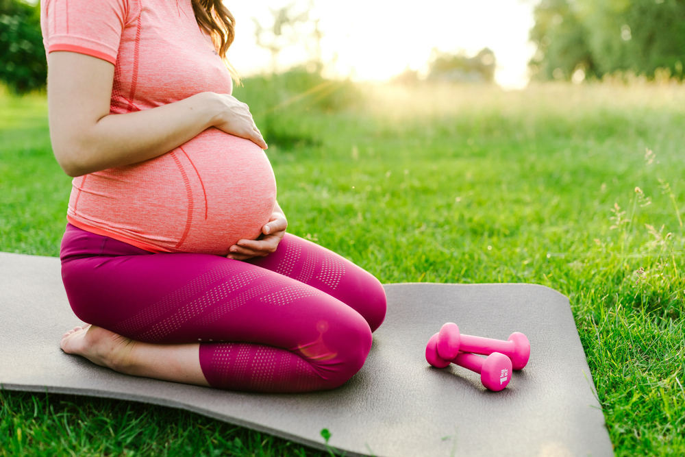 Pregnant woman doing outdoor exercise
