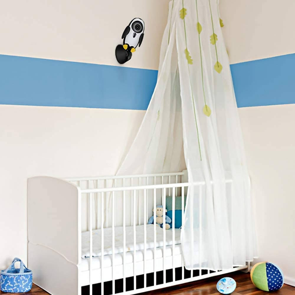 baby monitor over a baby crib on the wall