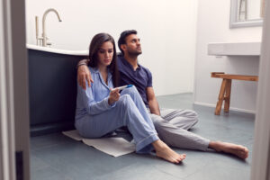 couple thinking and sitting sadly